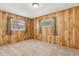 Bedroom with unique wooden paneling and carpet flooring, lit by two windows at 3994 Irma Shores Dr, Orlando, FL 32817