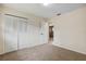 Cozy bedroom featuring neutral walls, carpet flooring, and a closet with bi-fold doors at 3994 Irma Shores Dr, Orlando, FL 32817