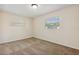 Neutral carpeted bedroom with two windows allowing ample natural light at 3994 Irma Shores Dr, Orlando, FL 32817