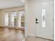 Entryway to a single Gathering home with luxury vinyl flooring, natural light, and a white front door at 3994 Irma Shores Dr, Orlando, FL 32817