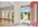 Entryway to a single Gathering home with luxury vinyl flooring, natural light, and a red front door at 3994 Irma Shores Dr, Orlando, FL 32817