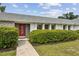 Front door to a charming single Gathering home surrounded by lush, green landscaping at 3994 Irma Shores Dr, Orlando, FL 32817