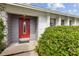 A close up of the front door to a charming home surrounded by green landscaping at 3994 Irma Shores Dr, Orlando, FL 32817