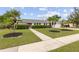 Charming single Gathering home with a well-manicured lawn and mature landscaping, including palm trees at 3994 Irma Shores Dr, Orlando, FL 32817