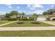 Charming single Gathering home with a well-manicured lawn and mature landscaping, including palm trees at 3994 Irma Shores Dr, Orlando, FL 32817