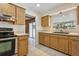 Well-lit kitchen showcasing wood cabinets, beige countertops, and stainless steel appliances at 3994 Irma Shores Dr, Orlando, FL 32817