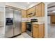 Modern kitchen equipped with stainless steel refrigerator, oven, and light wood cabinets at 3994 Irma Shores Dr, Orlando, FL 32817