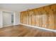 Living room featuring wood-look flooring and a unique wood accent wall at 3994 Irma Shores Dr, Orlando, FL 32817