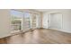 Bright living room featuring wood-look flooring and abundant natural light from three large windows at 3994 Irma Shores Dr, Orlando, FL 32817