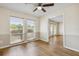 Inviting living room featuring two-tone walls, wood-look flooring, and natural light from two windows at 3994 Irma Shores Dr, Orlando, FL 32817