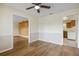 Spacious living room featuring wood-look flooring and views into the adjacent living areas and kitchen at 3994 Irma Shores Dr, Orlando, FL 32817