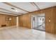 Large living room featuring paneled walls and tile flooring with exterior access at 3994 Irma Shores Dr, Orlando, FL 32817