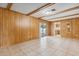 Spacious living room featuring paneled walls and tile flooring, with exterior access at 3994 Irma Shores Dr, Orlando, FL 32817