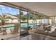 Enclosed patio featuring dining set, seating and swimming pool in background at 3994 Irma Shores Dr, Orlando, FL 32817
