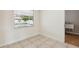 Sunlit room featuring view of a pool, neutral paint, and tile flooring at 3994 Irma Shores Dr, Orlando, FL 32817