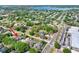 An aerial view of a home with neighboring houses, lush trees, and access to nearby roads and amenities at 418 Curry Ct, Altamonte Springs, FL 32714