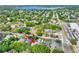 An aerial view shows the property surrounded by lush greenery and located in a residential area near a lake at 418 Curry Ct, Altamonte Springs, FL 32714