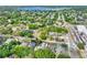 An aerial view shows the property surrounded by lush greenery and located in a residential area near a lake at 418 Curry Ct, Altamonte Springs, FL 32714