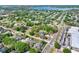 An aerial view of a home with neighboring houses, lush trees, and access to nearby roads and amenities at 418 Curry Ct, Altamonte Springs, FL 32714