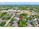 An aerial view showcases the property within a community close to local schools, a track field, and residential homes at 418 Curry Ct, Altamonte Springs, FL 32714