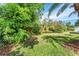 Lush backyard featuring mature landscaping, including bushes, plants, and green grass at 418 Curry Ct, Altamonte Springs, FL 32714