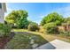 Spacious backyard featuring stepping stones, bushes, mature trees, and green grass at 418 Curry Ct, Altamonte Springs, FL 32714