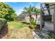 Backyard featuring a screened-in pool area, mature trees, landscaping, and manicured lawn at 418 Curry Ct, Altamonte Springs, FL 32714