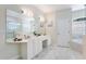 Elegant bathroom featuring double sinks, a soaking tub, and marble-style flooring, offering style and comfort at 418 Curry Ct, Altamonte Springs, FL 32714
