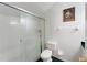 Bright bathroom featuring a tiled shower with glass door, toilet, towel rack, and picture frame at 418 Curry Ct, Altamonte Springs, FL 32714