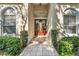 Elegant front entryway with tiled walkway, manicured bushes, and decorative glass double doors at 418 Curry Ct, Altamonte Springs, FL 32714