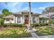 Charming single-story home with manicured landscaping and a bright red front door at 418 Curry Ct, Altamonte Springs, FL 32714