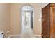 Hallway featuring arched doorways, built-in storage, and neutral tones leads to well-lit rooms with a cozy carpet at 418 Curry Ct, Altamonte Springs, FL 32714