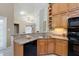 Cozy kitchen with oak cabinets, granite countertops, and breakfast bar at 418 Curry Ct, Altamonte Springs, FL 32714
