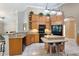 Open concept kitchen with a granite countertop island, oak cabinets, and black appliances at 418 Curry Ct, Altamonte Springs, FL 32714