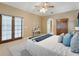 Spacious bedroom featuring a ceiling fan, french doors, and a stylish console table, providing comfort and convenience at 418 Curry Ct, Altamonte Springs, FL 32714