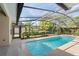 Inviting screened-in pool area with clear blue water and lush landscaping visible in the background at 418 Curry Ct, Altamonte Springs, FL 32714