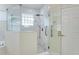 Modern shower with rainfall showerhead and handrails offers a luxurious and accessible bathing experience at 418 Curry Ct, Altamonte Springs, FL 32714