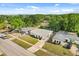 Aerial view of a cozy home with a well-kept lawn, lush trees, and nearby community amenities at 4246 Clarinda St, Orlando, FL 32811