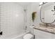 Stylish bathroom featuring subway tiles, a shower-tub combo and a granite countertop sink at 4246 Clarinda St, Orlando, FL 32811