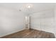 Neutral bedroom featuring modern vinyl floors, closet and access to an adjacent room at 4246 Clarinda St, Orlando, FL 32811