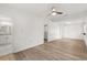 Spacious bedroom features wood-look floors, ceiling fan, and an ensuite bathroom and walk-in closet at 4246 Clarinda St, Orlando, FL 32811