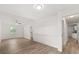 Large bedroom with ceiling fan, wood-look flooring, and hallway access to a bathroom and kitchen at 4246 Clarinda St, Orlando, FL 32811