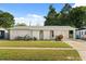 Charming single-story home featuring a well-maintained lawn and unique architectural details and covered parking at 4246 Clarinda St, Orlando, FL 32811