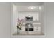 Kitchen view through serving hatch with granite countertop and an orchid pot at 4246 Clarinda St, Orlando, FL 32811