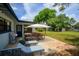 Outdoor patio features furniture and a grill, perfect for outdoor entertaining and relaxation with spacious yard and sheds at 4415 Gilpin Way, Orlando, FL 32812
