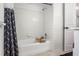 Clean bathroom with a white tile shower and black and white shower curtain at 4415 Gilpin Way, Orlando, FL 32812