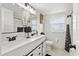 Modern bathroom featuring a double vanity with matte black fixtures and tiled backsplash at 4415 Gilpin Way, Orlando, FL 32812