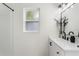 Bright bathroom features a vanity with modern fixtures, a framed mirror, and a shower with fresh white paint at 4415 Gilpin Way, Orlando, FL 32812