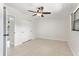 Bedroom features a ceiling fan, double closet, and tile floors at 4415 Gilpin Way, Orlando, FL 32812