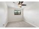 Cozy bedroom features a new ceiling fan, neutral paint, and carpet flooring at 4415 Gilpin Way, Orlando, FL 32812